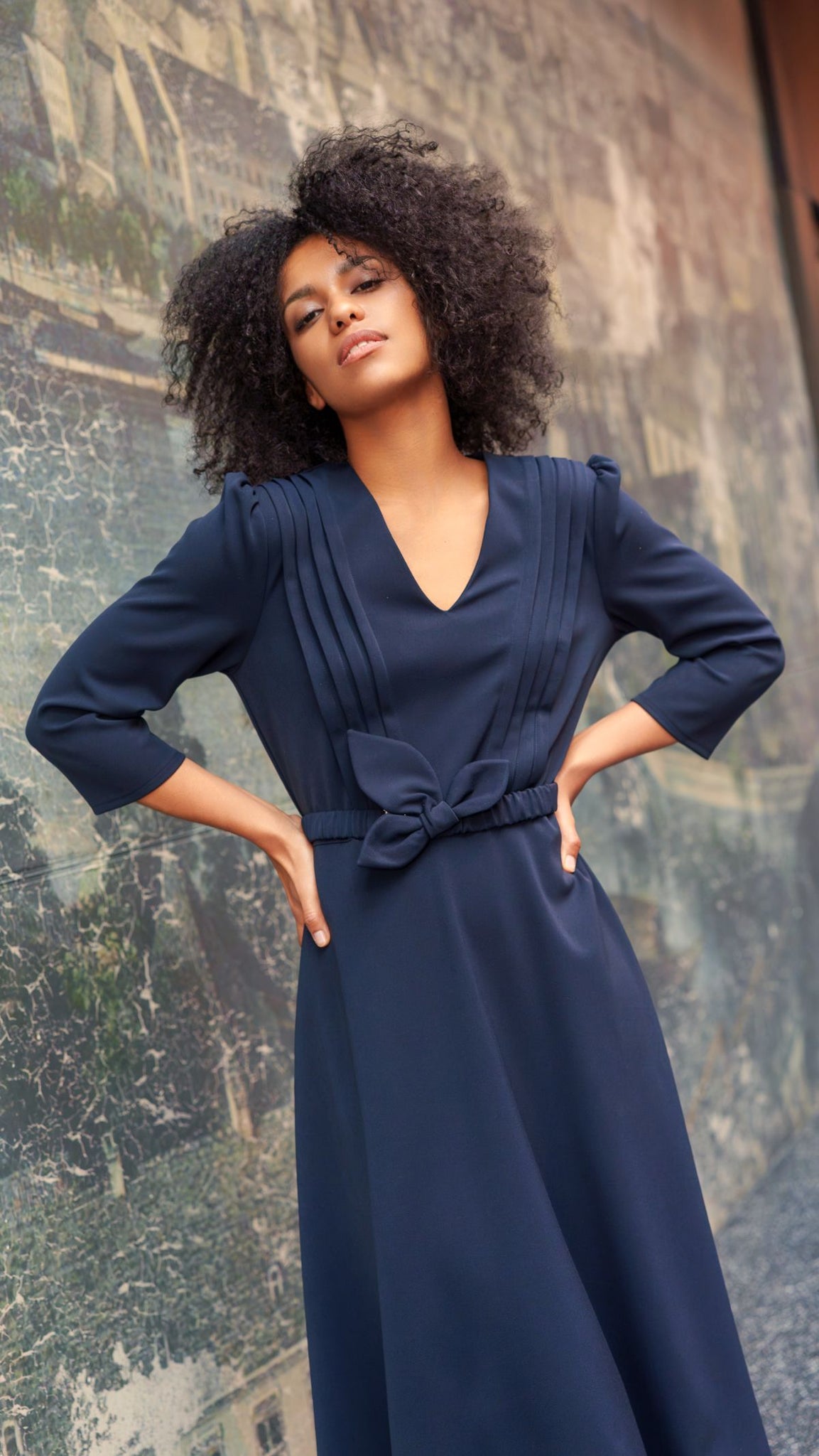 Navy blue dress with decorative pleats