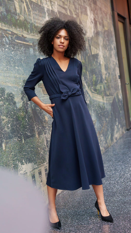 Navy blue dress with decorative pleats